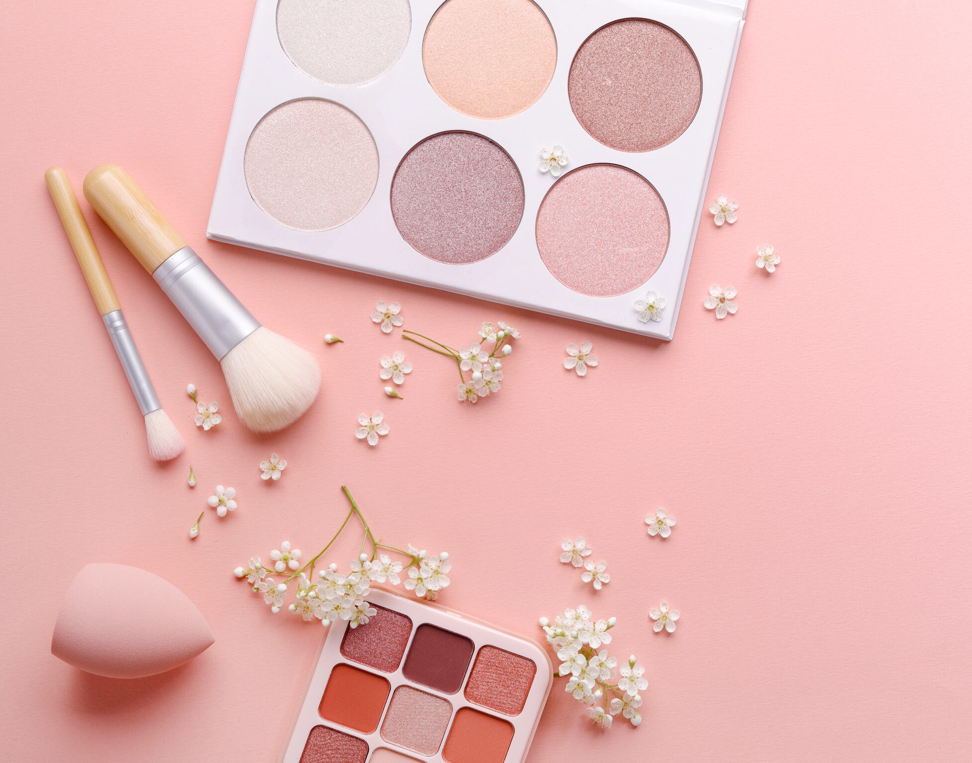 Makeup products on pink background