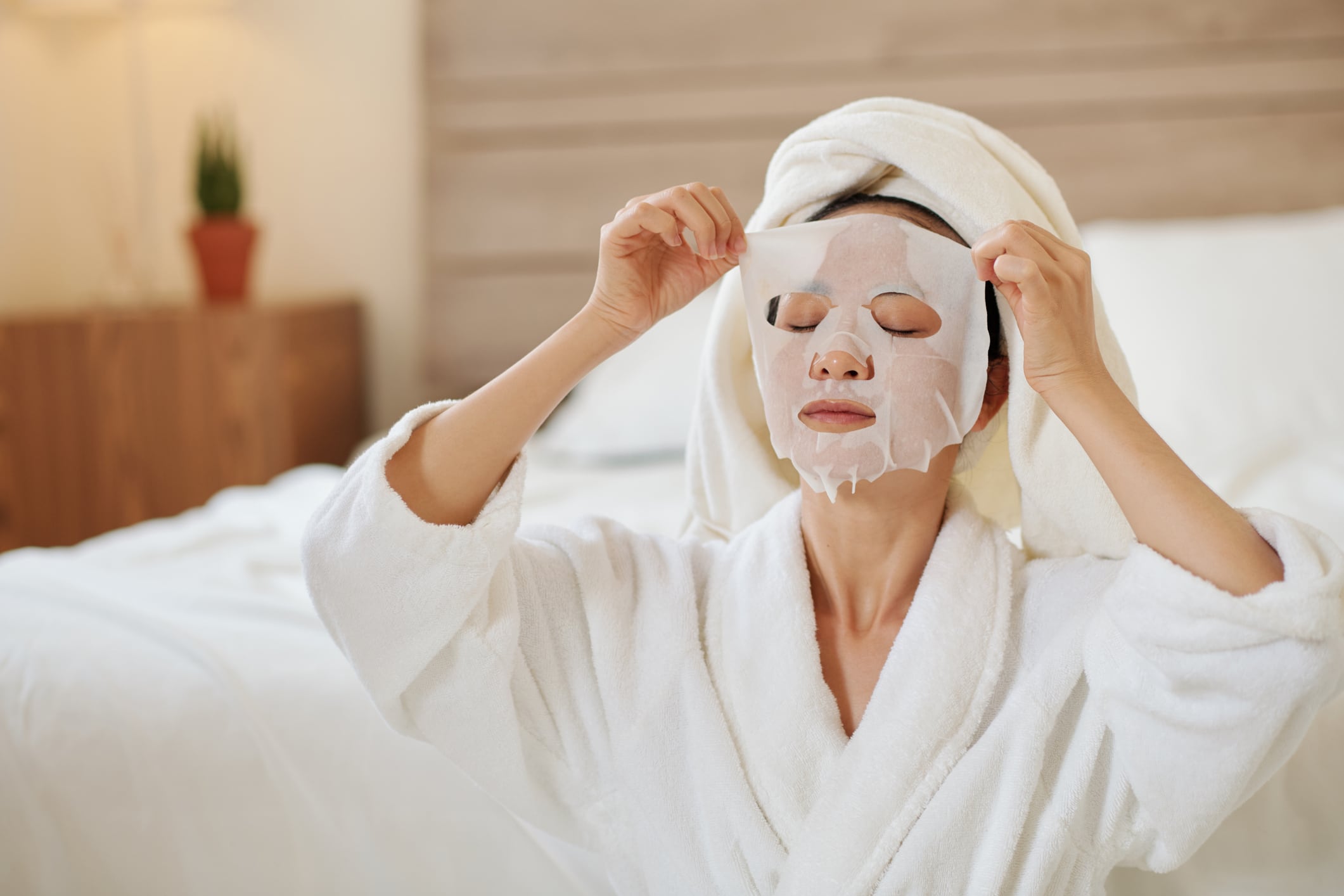 Woman taking off sheet mask