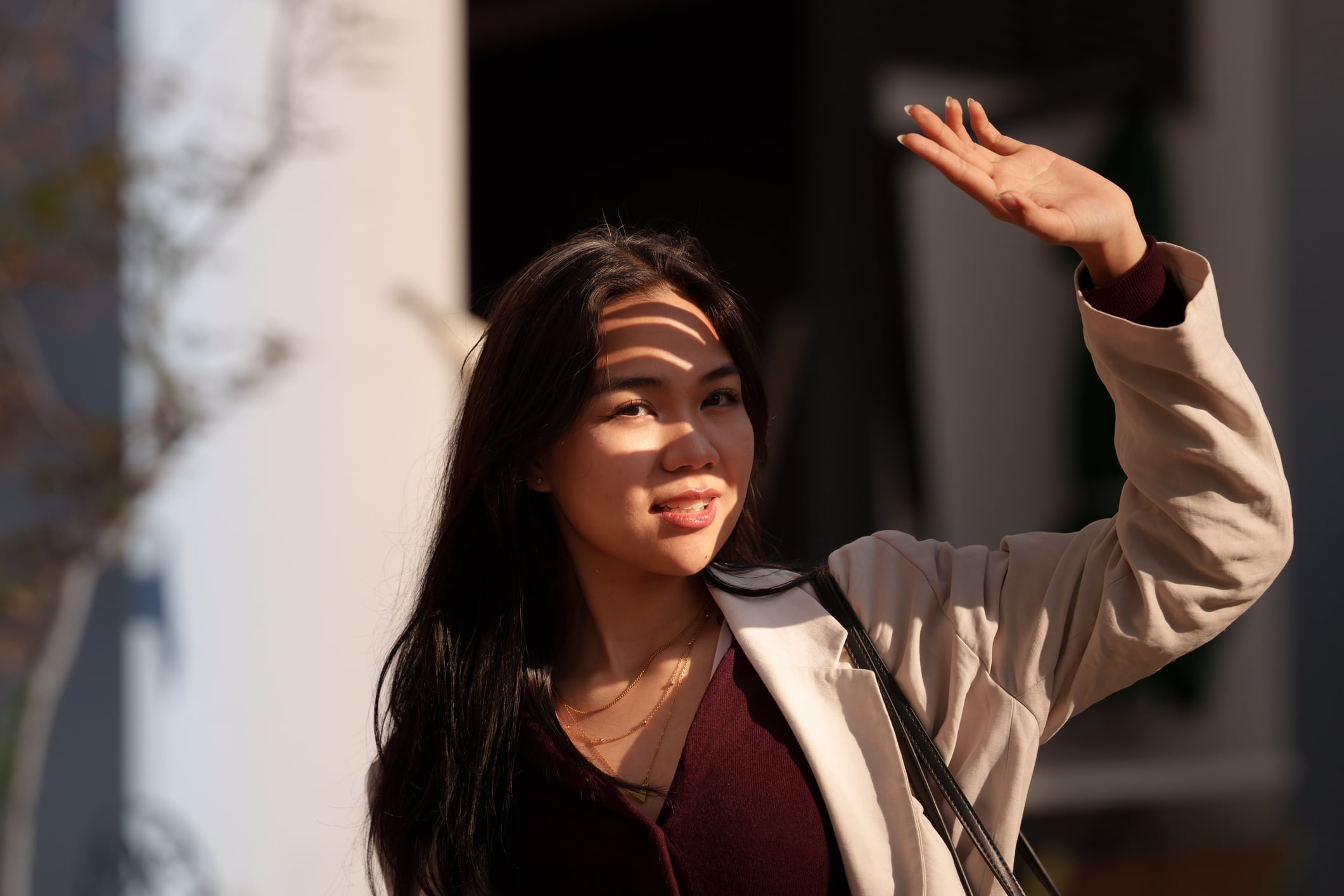 Asian woman shielding from sunlight