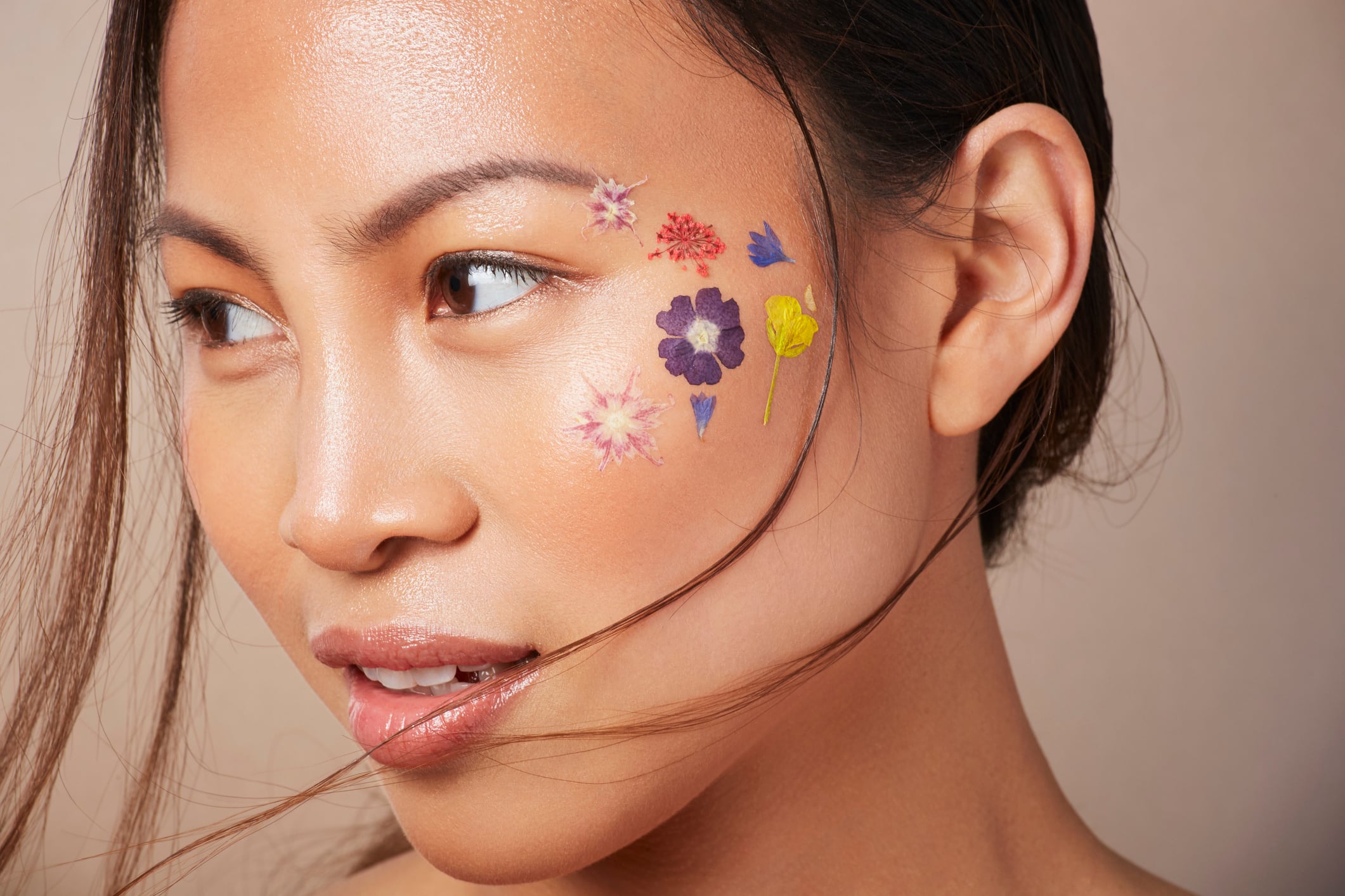 Woman with floral face paint on cheek