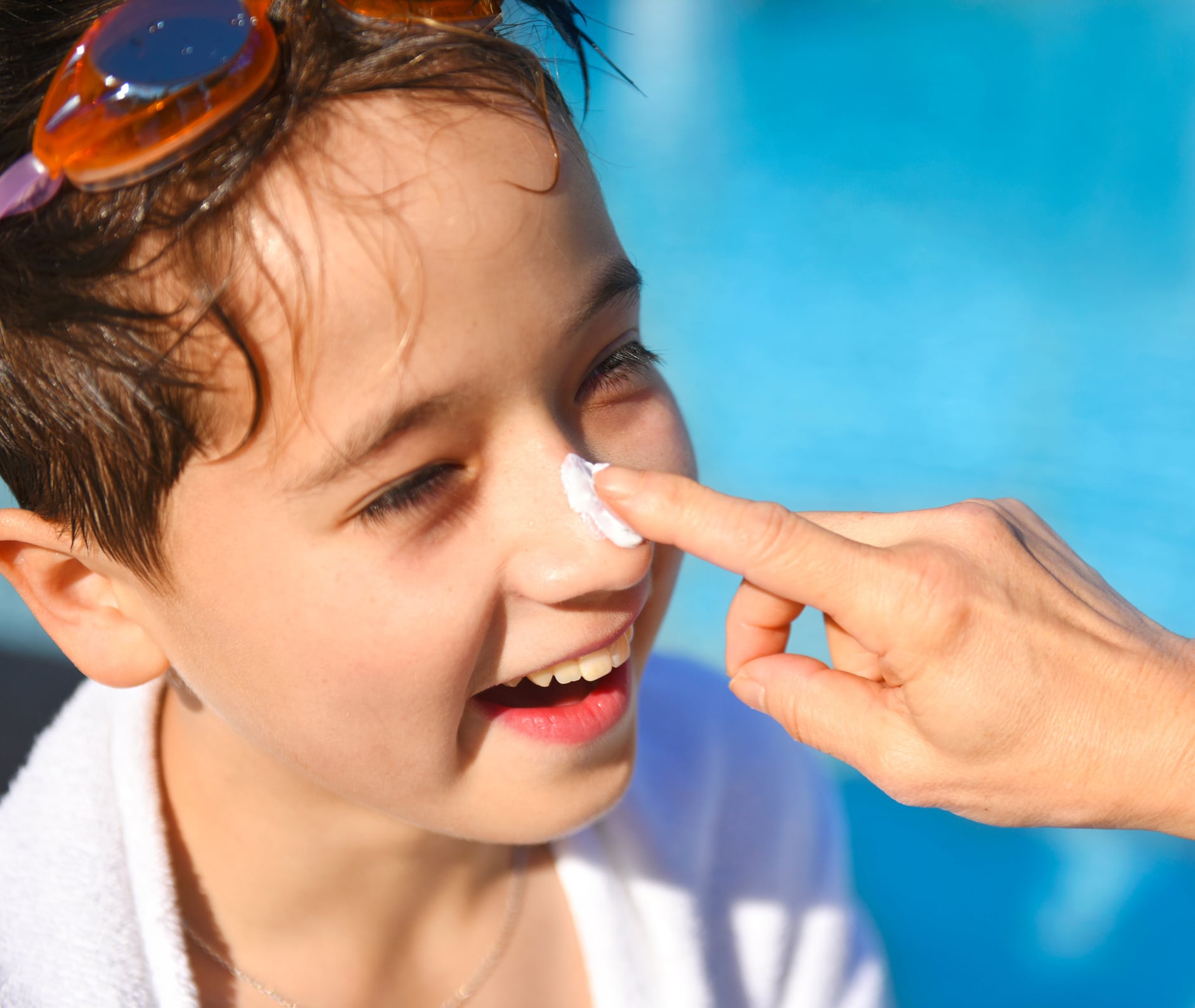 Applying sun cream on child