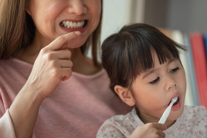 Providing good oral care for infants aged six months and up is encouraged to prevent the risk of halitosis and periodontal disease. © Getty Images